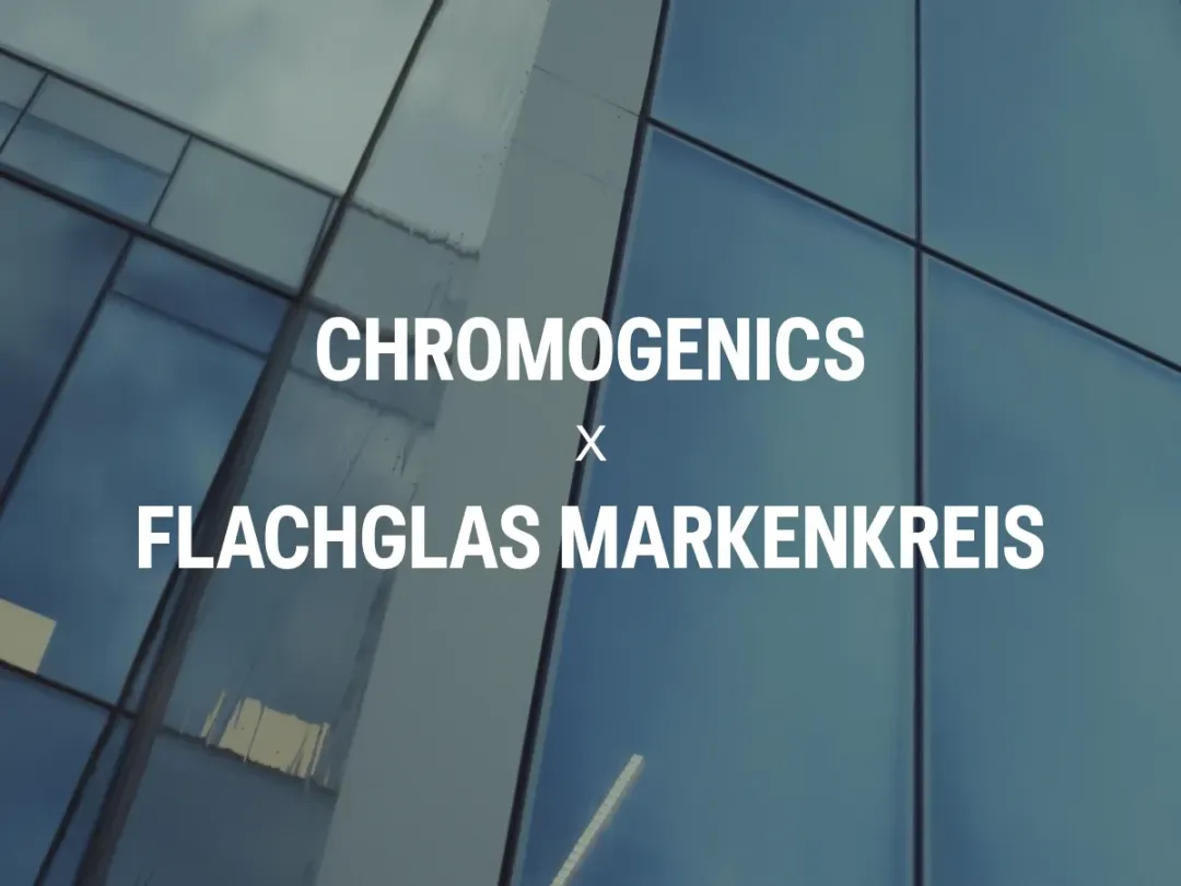 Glass facade with the text 'Chromogenics x Flacglas Markenkreis' in white against blue tinted glass.