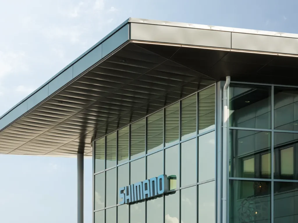 Entrance facade with large windows, blue Shimano logo.