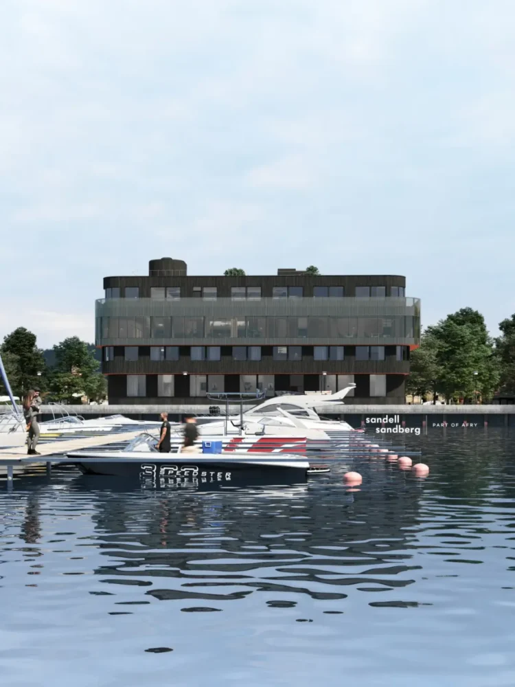 Rendering of a modern, dark-colored office building with large windows and rounded corners, situated by a marina with several boats docked in calm water.