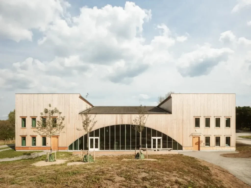 Light wooden building with rounded glass panels