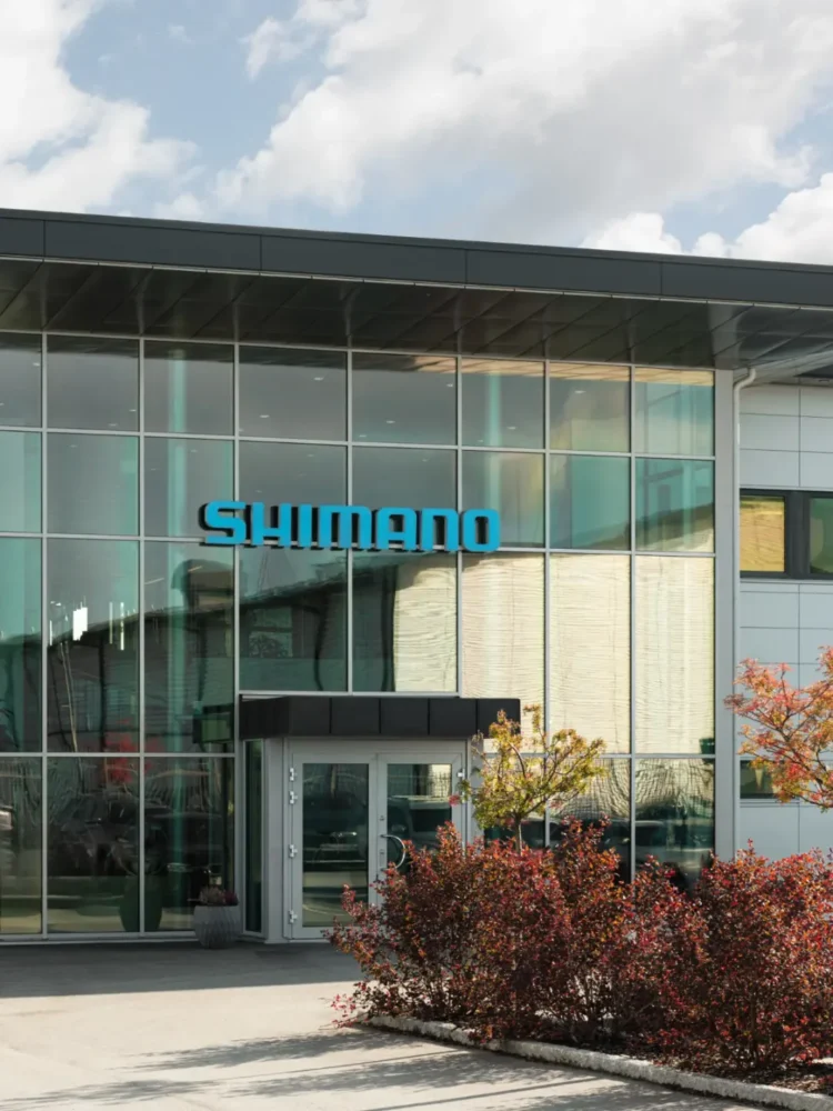 Entrance facade with large windows, blue Shimano logo.