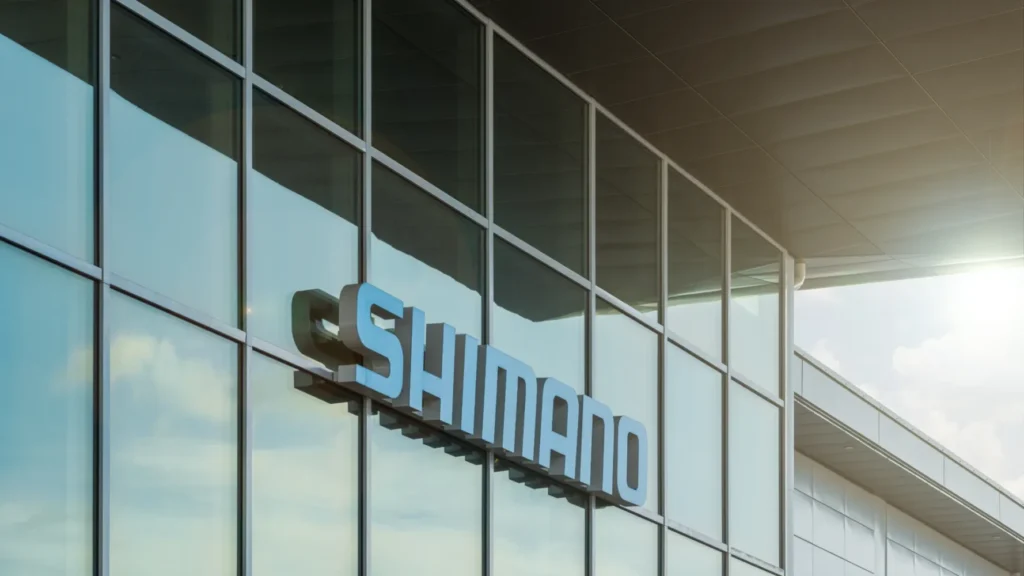 Entrance facade with large windows, blue Shimano logo.